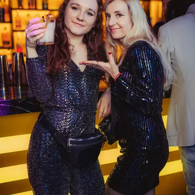 dwie dziewczyny wznoszą toast